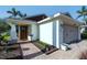 Well-kept home exterior with a brick walkway, wooden door, and attached garage at 4838 San Ortebello Dr, Bradenton, FL 34208