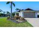 Charming home exterior with brick driveway, landscaped garden, and well-maintained lawn at 4838 San Ortebello Dr, Bradenton, FL 34208