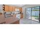 Bright kitchen features wood cabinets, gas range, and sliding glass doors to the outdoor area at 4838 San Ortebello Dr, Bradenton, FL 34208