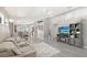 Open-concept living room with gray walls, modern furniture, ceiling fan, and wood-look floors at 4838 San Ortebello Dr, Bradenton, FL 34208