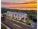 Aerial view of building exterior, sunset sky and water at 4950 Remington Dr # 114, Sarasota, FL 34234