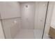 Modern bathroom with white tile shower and glass door with built in shelf and large shower head at 4950 Remington Dr # 114, Sarasota, FL 34234