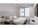 Sleek bedroom design with a padded headboard, contemporary furnishings, and modern wall art at 4950 Remington Dr # 114, Sarasota, FL 34234