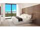 Bright bedroom featuring a decorative wood accent wall, balcony access, and picturesque treetop views at 4950 Remington Dr # 114, Sarasota, FL 34234