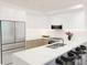 A modern kitchen featuring white cabinets, stainless steel appliances, and a stylish marble countertop with seating at 4950 Remington Dr # 114, Sarasota, FL 34234