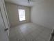 A bright bedroom features neutral walls, tile flooring, and a window bringing in natural light at 5002 26Th Avenue Dr E, Palmetto, FL 34221