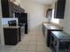 Modern kitchen showcasing stainless steel appliances, granite countertops, and dark wood cabinetry at 5002 26Th Avenue Dr E, Palmetto, FL 34221