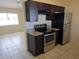 Modern kitchen featuring stainless steel appliances, granite countertops, and dark wood cabinetry at 5002 26Th Avenue Dr E, Palmetto, FL 34221