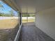 A screened patio with wood-look tile flooring and a view of the backyard at 5002 26Th Avenue Dr E, Palmetto, FL 34221