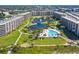 Aerial view of this large beach community with multiple pools and lush landscaping at 5780 Midnight Pass Rd # 410, Sarasota, FL 34242
