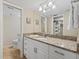Bathroom with granite vanity, white cabinets, and well-lit mirror at 5780 Midnight Pass Rd # 410, Sarasota, FL 34242