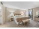 Spacious bedroom features a comfortable bed, stylish furnishings, and a private balcony at 5780 Midnight Pass Rd # 410, Sarasota, FL 34242
