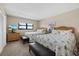 Cozy bedroom features two comfortable beds, natural light, and neutral decor at 5780 Midnight Pass Rd # 410, Sarasota, FL 34242