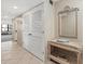 Neutral-toned hallway with a decorative mirror, table and storage closet at 5780 Midnight Pass Rd # 410, Sarasota, FL 34242