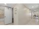 Hallway view with an open bathroom and a view of the living room area at 5780 Midnight Pass Rd # 410, Sarasota, FL 34242