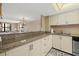 Well-equipped kitchen with stone countertops, backsplash, and white cabinetry at 5780 Midnight Pass Rd # 410, Sarasota, FL 34242