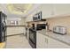 View of the kitchen featuring light-toned cabinetry, stainless steel appliances and granite countertops at 5780 Midnight Pass Rd # 410, Sarasota, FL 34242