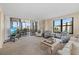 Bright living room features a private balcony with beautiful water views and comfortable seating at 5780 Midnight Pass Rd # 410, Sarasota, FL 34242