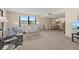 Living room featuring a couch, love seat, dining area, and large window with a view at 5780 Midnight Pass Rd # 410, Sarasota, FL 34242