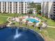 Aerial view of the beautiful pool and lake with fountain at this condo community at 5780 Midnight Pass Rd # 410, Sarasota, FL 34242