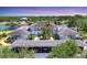 Aerial view of property with covered parking, water views, and lush landscaping at 623 Estuary Dr, Bradenton, FL 34209
