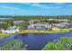 Aerial view displays lakeside residences, pool, and lush landscaping in this serene community at 623 Estuary Dr, Bradenton, FL 34209