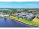 Aerial view of waterfront community featuring multiple residences, a pool, and picturesque lakefront settings at 623 Estuary Dr, Bradenton, FL 34209