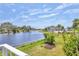 Scenic backyard overlooks a tranquil lake with lush greenery and a well-maintained lawn at 623 Estuary Dr, Bradenton, FL 34209