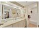 Neutral bathroom features a large mirror over a marble countertop and updated fixtures at 623 Estuary Dr, Bradenton, FL 34209