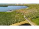 An aerial view of a wooden dock that extends into the community's waterway at 623 Estuary Dr, Bradenton, FL 34209