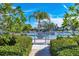 Entrance to a community pool, surrounded by lush greenery and palm trees at 623 Estuary Dr, Bradenton, FL 34209