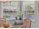 Light-filled dining area with a view of the lake from large picture windows at 623 Estuary Dr, Bradenton, FL 34209