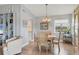 Bright dining room with wood floors, a chandelier, and views of the water at 623 Estuary Dr, Bradenton, FL 34209