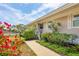 Beautifully landscaped front yard with colorful flowers and view of the water at 623 Estuary Dr, Bradenton, FL 34209