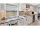 Modern kitchenette featuring stainless steel appliances, and white cabinetry at 623 Estuary Dr, Bradenton, FL 34209