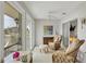 Inviting lanai showcases lake views, ceiling fan, and cozy wicker furniture, perfect for relaxation at 623 Estuary Dr, Bradenton, FL 34209