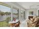 Bright lanai with tile flooring, ceiling fan, and stunning lake views through sliding glass doors at 623 Estuary Dr, Bradenton, FL 34209