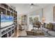 Bright living room featuring hardwood floors, and a large built-in shelving unit at 623 Estuary Dr, Bradenton, FL 34209