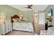 Bright main bedroom with a ceiling fan, wood floors, and light green walls at 623 Estuary Dr, Bradenton, FL 34209