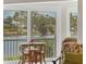Cozy enclosed porch with outdoor seating and views of the water at 623 Estuary Dr, Bradenton, FL 34209