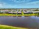 Aerial view showcasing home with screened in pool area with lake view at 6252 Winding Pine Dr, Nokomis, FL 34275