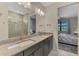 Bathroom vanity featuring granite countertops and dual sinks with a view to the bedroom at 6252 Winding Pine Dr, Nokomis, FL 34275