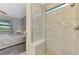 Beautifully tiled shower with glass door and pebble floor in well-lit bathroom at 6252 Winding Pine Dr, Nokomis, FL 34275