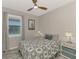 Comfortable bedroom with a ceiling fan, natural light from the window, and neutral décor at 6252 Winding Pine Dr, Nokomis, FL 34275