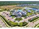Aerial view of the community center with pool, tennis courts, and parking at 6252 Winding Pine Dr, Nokomis, FL 34275
