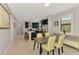 Bright dining room area with modern table, chairs, and kitchen view at 6252 Winding Pine Dr, Nokomis, FL 34275