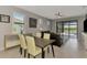 Open dining area that flows to living room with views of the pool at 6252 Winding Pine Dr, Nokomis, FL 34275