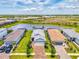 Aerial view of charming single-Gathering homes with beautiful landscaping and lake views in a desirable community at 6252 Winding Pine Dr, Nokomis, FL 34275