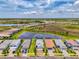 Aerial view of a home with beautiful landscaping and lake views in a desirable community at 6252 Winding Pine Dr, Nokomis, FL 34275