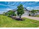 Well-maintained home featuring lush landscaping, a two-car garage, and a brick driveway at 6252 Winding Pine Dr, Nokomis, FL 34275